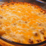 Hobo Casserole with ground beef and vegetables in a cast iron skillet.