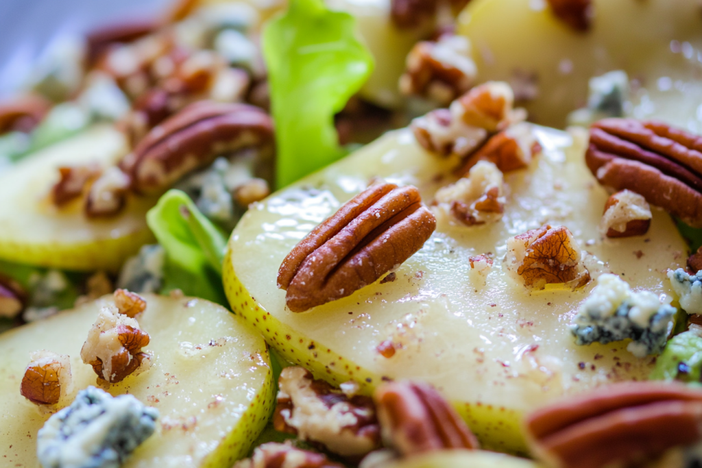 Close-up of pear, blue cheese, and pecans in a delicious salad.